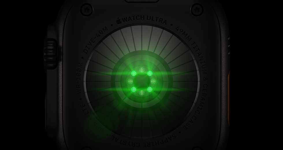 Back of Apple Watch Ultra 4, titanium case, black colour, multiple round sensors with glowing green LED lights